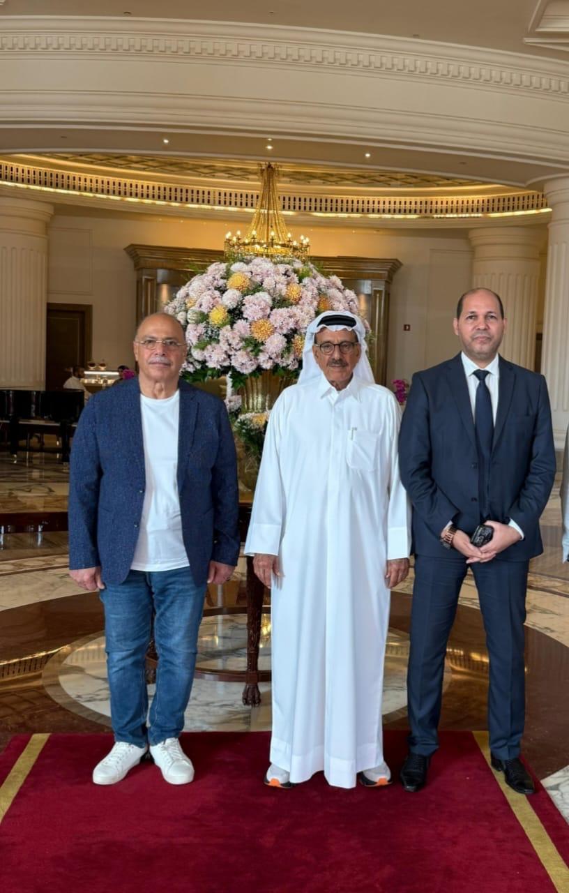 Three men photographed in a hotel lobby ahead of the forum