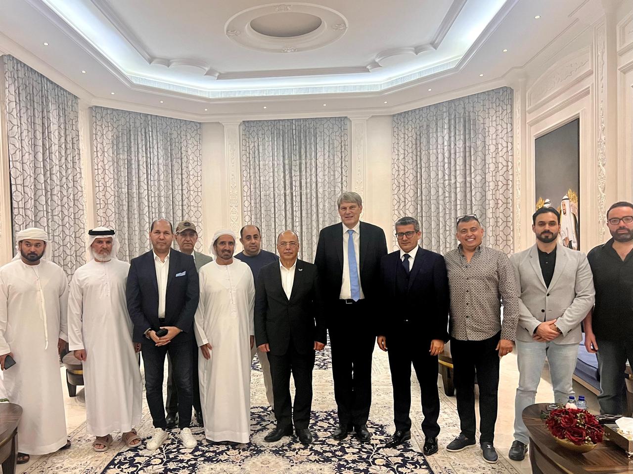 Group of forum committee members and guests standing together in a majlis